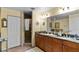 Double vanity bathroom with granite countertops and large shower at 6312 Buford St # 303, Orlando, FL 32835