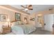 King-size bed, ceiling fan, and ensuite bathroom access at 6312 Buford St # 303, Orlando, FL 32835