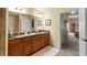 Double vanity bathroom with granite countertops and view of bedroom at 6312 Buford St # 303, Orlando, FL 32835