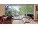 Living room with sliding glass doors leading to a balcony at 6312 Buford St # 303, Orlando, FL 32835