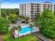 Community pool with surrounding landscaping at 6312 Buford St # 303, Orlando, FL 32835