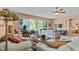 Open concept living room with access to balcony and bedroom at 6312 Buford St # 303, Orlando, FL 32835