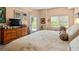 Spacious bedroom with large bed, dresser, and access to a private balcony at 6312 Buford St # 303, Orlando, FL 32835