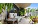 Relaxing balcony featuring outdoor seating and tropical landscaping at 6312 Buford St # 303, Orlando, FL 32835