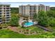 Condo building with pool and boardwalk over water at 6312 Buford St # 303, Orlando, FL 32835
