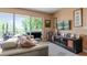 Comfortable living room with a large TV and balcony access at 6312 Buford St # 303, Orlando, FL 32835