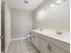Bathroom with double vanity and patterned floor tile at 7521 Laureate Blvd # 5304, Orlando, FL 32827