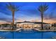 Resort-style pool with lounge chairs and palm trees at sunset at 7521 Laureate Blvd # 5304, Orlando, FL 32827