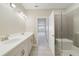 Bathroom with double vanity, shower, and patterned tile at 7521 Laureate Blvd # 5304, Orlando, FL 32827