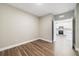 Bright bedroom with wood-look floors and view to kitchen at 7521 Laureate Blvd # 5304, Orlando, FL 32827