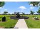 Community playground with play equipment and benches at 875 Fillmore Ct, Davenport, FL 33837
