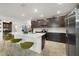Modern kitchen with dark cabinetry, quartz countertops, and an island at 875 Fillmore Ct, Davenport, FL 33837