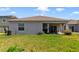 Rear view of house showcasing backyard and patio at 875 Fillmore Ct, Davenport, FL 33837