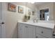 Bright bathroom with white vanity, mirror, and coastal artwork at 3587 Casalta Cir, New Smyrna Beach, FL 32168
