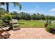 Brick patio area with wooden chairs and tranquil pond view at 3587 Casalta Cir, New Smyrna Beach, FL 32168