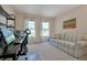 Home office with desk, chair, sofa, and large windows at 3587 Casalta Cir, New Smyrna Beach, FL 32168