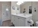 Double vanity bathroom with a large mirror and toilet at 3587 Casalta Cir, New Smyrna Beach, FL 32168