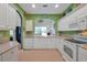 Modern kitchen with white cabinets, granite counters and stainless steel appliances at 3587 Casalta Cir, New Smyrna Beach, FL 32168