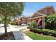 Townhomes with lush landscaping and American flags at 3587 Casalta Cir, New Smyrna Beach, FL 32168