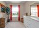 Bright bedroom with a large window, white dresser, and woven baskets at 3587 Casalta Cir, New Smyrna Beach, FL 32168