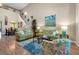 Spacious living room with hardwood floors, comfy seating and large artwork at 3587 Casalta Cir, New Smyrna Beach, FL 32168
