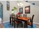 Charming dining room with a wood table and six chairs, view to living room at 3587 Casalta Cir, New Smyrna Beach, FL 32168