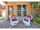 Relaxing front porch with wicker chairs and colorful pillows at 3587 Casalta Cir, New Smyrna Beach, FL 32168