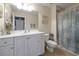 Clean bathroom with white vanity, shower, and beach-themed decor at 3587 Casalta Cir, New Smyrna Beach, FL 32168