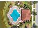 Overhead view of a community pool and adjacent building at 3587 Casalta Cir, New Smyrna Beach, FL 32168