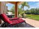 Relaxing patio with lounge chairs and built-in grill overlooking a pond at 3587 Casalta Cir, New Smyrna Beach, FL 32168