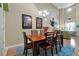 Bright dining room with wood table and six chairs, view of living room at 3587 Casalta Cir, New Smyrna Beach, FL 32168