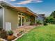 Spacious back patio with awning, pavers, and lush landscaping at 251 Silver Maple Rd, Groveland, FL 34736