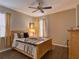 Cozy bedroom with wood flooring, wooden bed frame, and neutral color palette at 251 Silver Maple Rd, Groveland, FL 34736