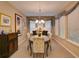 Elegant dining room with ornate chandelier, patterned chairs, and large windows at 251 Silver Maple Rd, Groveland, FL 34736