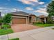 Attractive single-story home with brick paver driveway and landscaped lawn at 251 Silver Maple Rd, Groveland, FL 34736