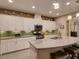 Island kitchen with granite countertops and white cabinetry at 251 Silver Maple Rd, Groveland, FL 34736