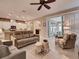 Open living room with a view of the kitchen and sunroom at 251 Silver Maple Rd, Groveland, FL 34736