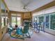 Bright sunroom with fireplace, comfortable seating, and access to backyard at 251 Silver Maple Rd, Groveland, FL 34736