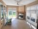 Bright sunroom with fireplace and comfortable seating, offering a relaxing space at 251 Silver Maple Rd, Groveland, FL 34736