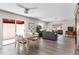 Bright living room with grey sofas, wood-look floors, and access to a patio at 310 Guido Ave, The Villages, FL 32159