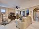 Spacious living room with light leather couches and a large TV at 251 Silver Maple Rd, Groveland, FL 34736