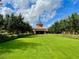 Grand community clubhouse with manicured lawn at 251 Silver Maple Rd, Groveland, FL 34736