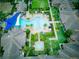 Resort-style pool with expansive deck and lush landscaping at 251 Silver Maple Rd, Groveland, FL 34736