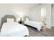 Two twin beds, nightstand, and en-suite bathroom access at 1136 Castle Pines Ct, Reunion, FL 34747