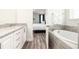 Bathroom with a double vanity, soaking tub, and granite countertop at 1136 Castle Pines Ct, Reunion, FL 34747