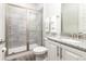 Bathroom with shower and granite vanity at 1136 Castle Pines Ct, Reunion, FL 34747