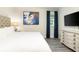 Spacious bedroom with king-size bed, large TV, and ample dresser storage at 1136 Castle Pines Ct, Reunion, FL 34747