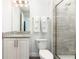 Bathroom with granite countertop and walk-in shower at 1136 Castle Pines Ct, Reunion, FL 34747