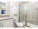 Bathroom with granite countertop, white cabinets, and a walk-in shower at 1136 Castle Pines Ct, Reunion, FL 34747