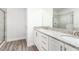 Bathroom with a double vanity, granite countertop, and a shower at 1136 Castle Pines Ct, Reunion, FL 34747